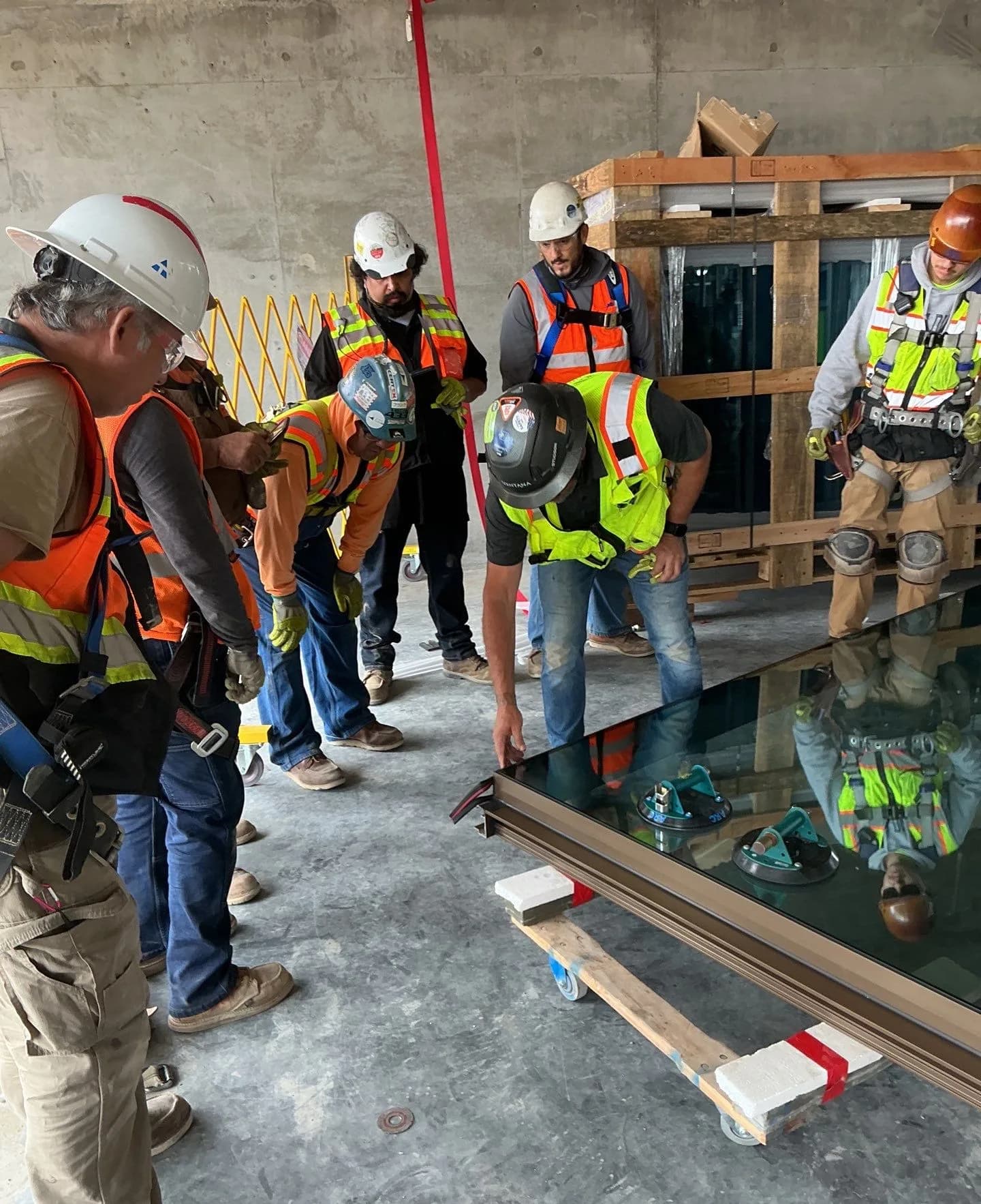 AR Contract Glazing crew setting a curtain-wall glass unit at the Hollywood Park job
